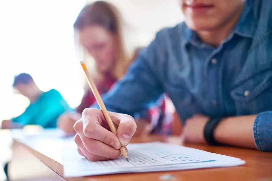 College boy and his fellow students taking a test