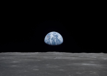 View of Moon limb with Earth on the horizon,Mare Smythii Region. Earth rise. This image was taken before separation of the LM and the Command Module during Apollo 11 Mission. Original film magazine was labeled V. Film Type: S0-368 Color taken with a 250mm lens.  Approximate photo scale 1:1,300,000. Principal Point Latitude was 3 North by Longitude 85 East. Foward overlap is 90%. Sun angle is High. Approximate Tilt minimum is 65 degrees,maximum is 69. Tilt direction is West (W).